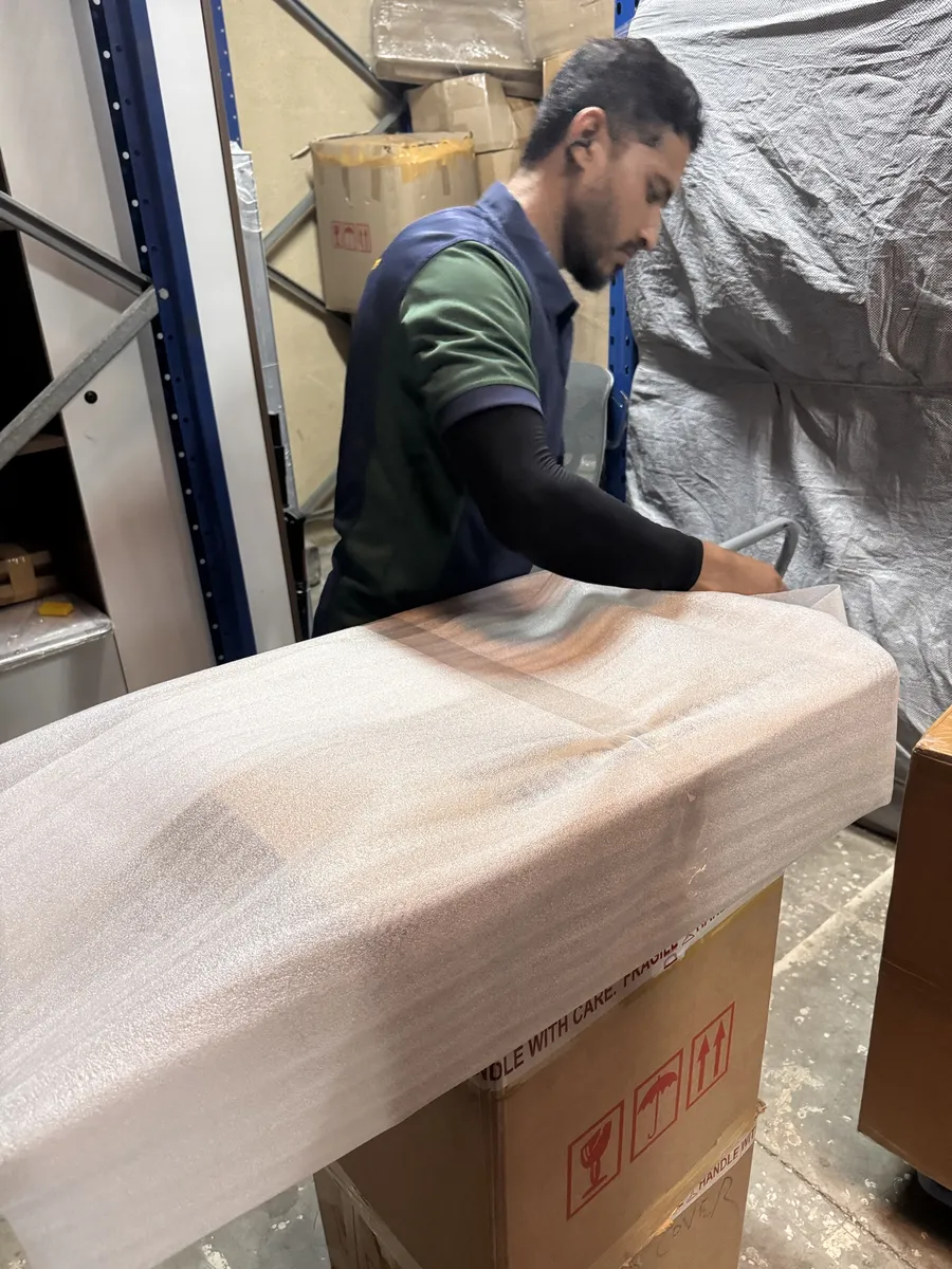 GPS Movers crew member covering a packed item with foam sheet