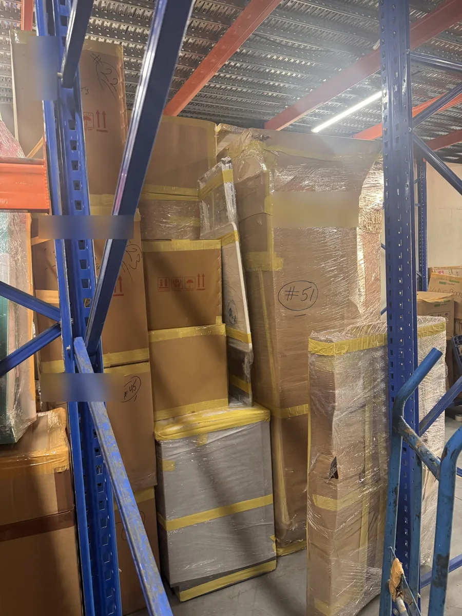 Wrapped and numbered household goods on racking in the GPS Movers Ras Al Khor warehouse